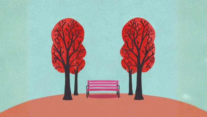 panchina rossa fra due alberi rossi 